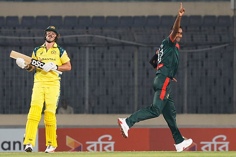 Bangladesh's Shoriful Islam, right celebrates the wicket of Australia's Ben Dwarshuis, left, during the third one day international cricket match between Australia and Bangladesh, in Mirpur, Bangladesh.