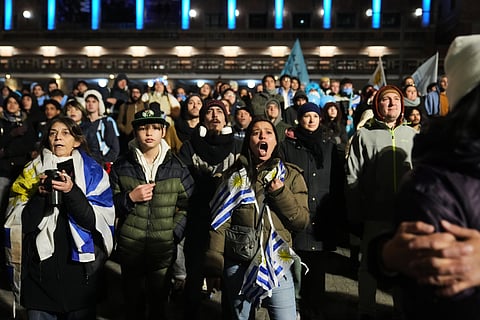 Fans watch the World Cup soccer match between Uruguay and Saudi Arabia, in Montevideo, Uruguay Monday, June 15, 2026.