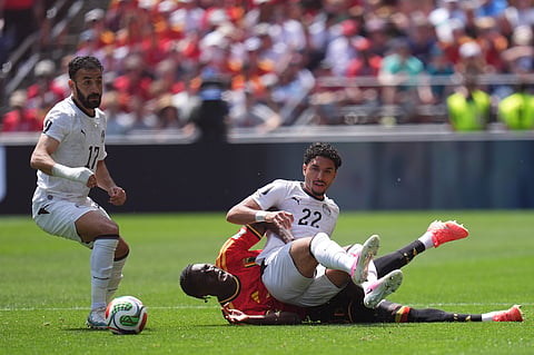 Egypt's Omar Marmoush, front, is brought down by Belgium's Amadou Onana during the World Cup Group G soccer match between Belgium and Egypt in Seattle, Monday, June 15, 2026.