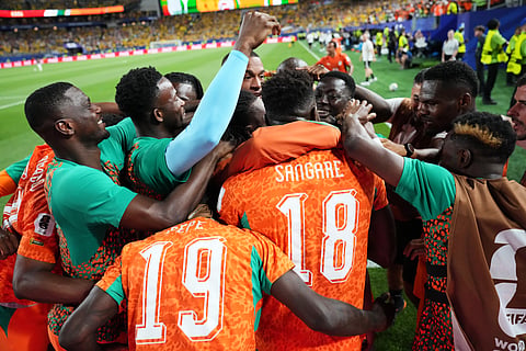 Ivory Coast's Amad Diallo, obscured, is surrounded by teammates after scoring their first goal during the World Cup Group E soccer match between Ivory Coast and Ecuador in Philadelphia, Sunday, June 14, 2026.