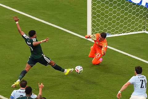 Saudi Arabia's Abdulelah Alamri (4) shoots and scores their opening goal against Uruguay goalkeeper Fernando Muslera (23) during the World Cup Group H soccer match between Saudi Arabia and Uruguay in Miami Gardens, Fla., Monday, June 15, 2026.