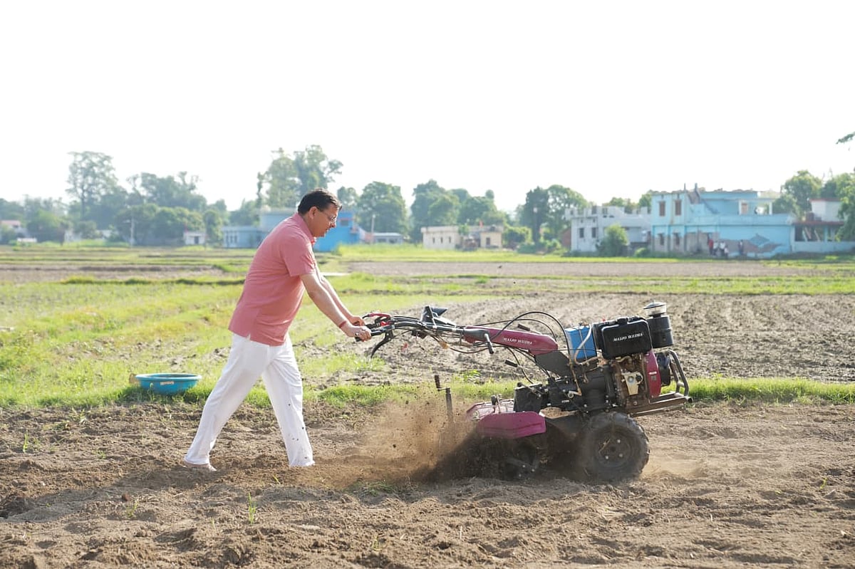 Uttarakhand Chief Minister Pushkar Singh Dhami operating a tiller in a field - null
