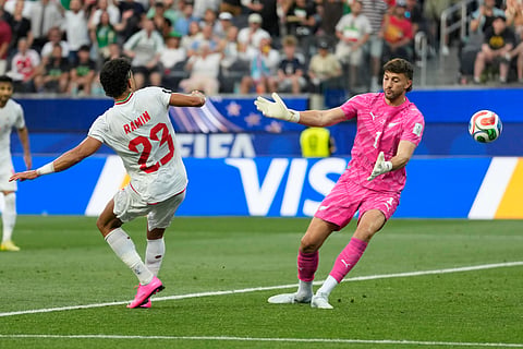 Iran's Ramin Rezaeian (23) scores a goal against New Zealand goalkeeper Max Crocombe (1) during the World Cup Group G soccer match between Iran and New Zealand in Inglewood, Calif., near Los Angeles, Monday, June 15, 2026.