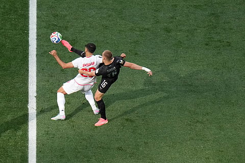 New Zealand's Finn Surman (16) challenges for the ball with Iran's Shahriyar Moghanloo (20) during the World Cup Group G soccer match between Iran and New Zealand in Inglewood, Calif., near Los Angeles, Monday, June 15, 2026.