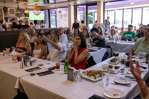 Fans watch a televised World Cup Group G soccer match between Iran and New Zealand, Monday, June 15, 2026, in Los Angeles.