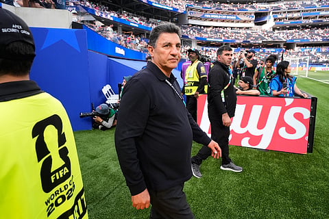 Iran head coach Amir Ghalenoei walks on the field before the World Cup Group G soccer match between Iran and New Zealand in Inglewood, Calif., near Los Angeles, Monday, June 15, 2026.