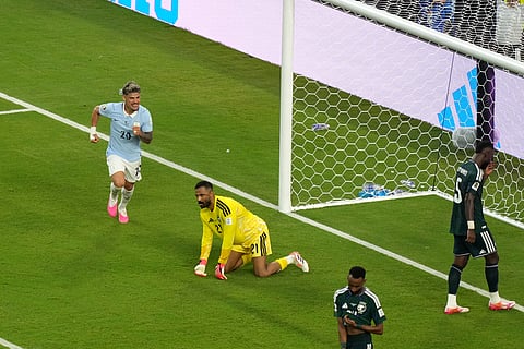Uruguay's Maxi Araujo (20) celebrates after scoring their opening goal against Saudi Arabia goalkeeper Mohammed Alowais (21) during the World Cup Group H soccer match between Saudi Arabia and Uruguay in Miami Gardens, Fla., Monday, June 15, 2026.