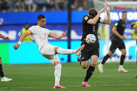 Iran's Mehdi Taremi (9) battles for the ball with New Zealand's Chris Wood (9) during the World Cup Group G soccer match between Iran and New Zealand in Inglewood, Calif., near Los Angeles, Monday, June 15, 2026.