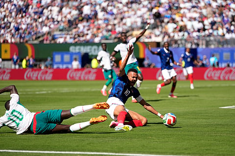 Senegal's Sadio Mane, left, stops France's Kylian Mbappe during the World Cup Group I soccer match between France and Senegal in East Rutherford, N.J., near New York, Tuesday, June 16, 2026.