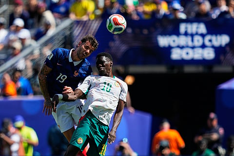 France's Theo Hernandez, left, jumps for the ball with Senegal's Ismaila Sarr during the World Cup Group I soccer match between France and Senegal in East Rutherford, N.J., near New York, Tuesday, June 16, 2026.