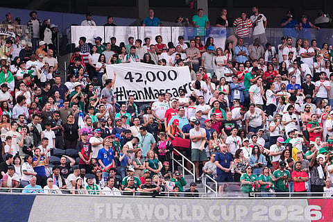 Fans hold a sign reading "42,000 #IranMassacre" during the World Cup Group G soccer match between Iran and New Zealand in Inglewood, Calif., near Los Angeles, Monday, June 15, 2026.