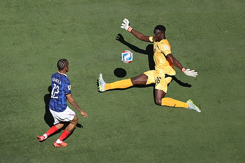 France's Bradley Barcola (12) scoreas a goal against Senegal goalkeeper Edouard Mendy (16) during the World Cup Group I soccer match between France and Senegal in East Rutherford, N.J., near New York, Tuesday, June 16, 2026.