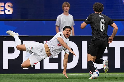 Iran's Arya Yousefi (17) and New Zealand's Joe Bell (6) battle for the ball during the World Cup Group G soccer match between Iran and New Zealand in Inglewood, Calif., near Los Angeles, Monday, June 15, 2026.