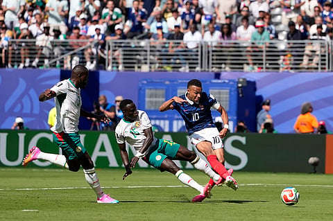 France's Kylian Mbappe, right, makes an attempt to score as Senegal's Krepin Diatta tries to stop him during the World Cup Group I soccer match between France and Senegal in East Rutherford, N.J., near New York, Tuesday, June 16, 2026.