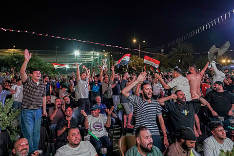 Iraqi soccer fans react as they watch the World Cup match between Iraq and Norway on a large screen in downtown Baghdad, Iraq, early Wednesday, June 17, 2026.