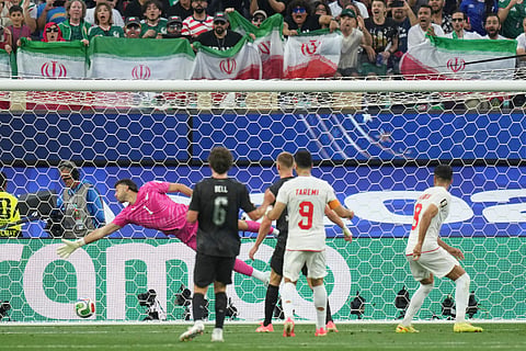 New Zealand goalkeeper Max Crocombe (1) fails to block a shot from Iran's Mohammad Mohebbi (8) during the World Cup Group G soccer match between Iran and New Zealand in Inglewood, Calif., near Los Angeles, Monday, June 15, 2026.