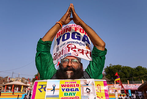 A participant performs a yoga pose during the Gangotri-to-Ganga Sagar 'Yoga Stream' campaign ahead of International Yoga Day, in Prayagraj.