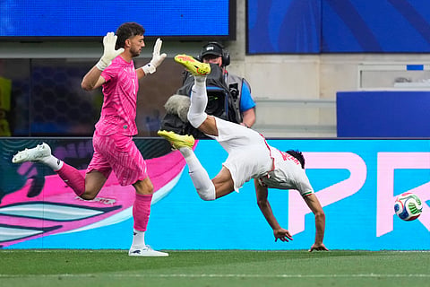 New Zealand goalkeeper Max Crocombe (1) reacts as Iran's Mohammad Mohebbi (8) falls during the World Cup Group G soccer match between Iran and New Zealand in Inglewood, Calif., near Los Angeles, Monday, June 15, 2026.