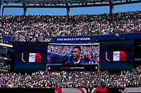 AP Photo/Frank Franklin II : France's Kylian Mbappe is seen on the screen as he sings the national anthem before the start of the World Cup Group I soccer match between France and Senegal in East Rutherford, N.J., near New York, Tuesday, June 16, 2026.