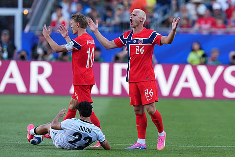 Norway's Julian Ryerson, right, and Martin Oedegaard reacts as Iraq's Merchas Doski lies on the pitch during the World Cup Group I soccer match between Iraq and Norway in Foxborough, Mass., near Boston, Tuesday, June 16, 2026.