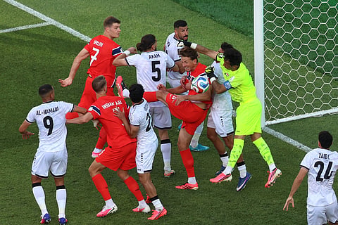 Iraq goalkeeper Jalal Hassan (12) blocks a corner kick during the World Cup Group I soccer match between Iraq and Norway in Foxborough, Mass., near Boston, Tuesday, June 16, 2026.