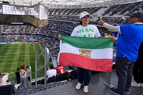 An Iran fan holds up a flag before the World Cup Group G soccer match between Iran and New Zealand in Inglewood, Calif., near Los Angeles, Monday, June 15, 2026.