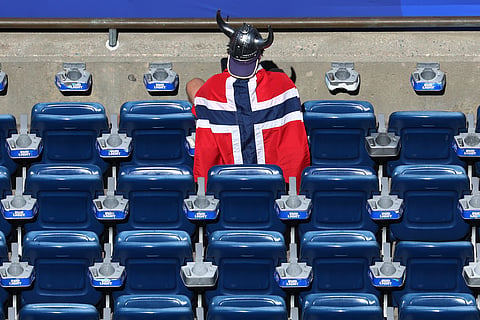 A Norway fan dons a viking helmet nd flag waiting for the start of the World Cup Group I soccer match between Iraq and Norway in Foxborough, Mass., near Boston, Tuesday, June 16, 2026.