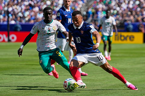 France's Kylian Mbappe tries to dribble the ball past Senegal's Idrissa Gana Gueye, left, during the World Cup Group I soccer match between France and Senegal in East Rutherford, N.J., near New York, Tuesday, June 16, 2026.