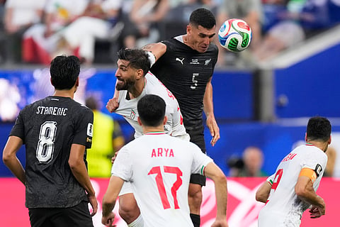 Iran's Shahriyar Moghanloo (20) battles for a header with New Zealand's Michael Boxall (5) during the World Cup Group G soccer match between Iran and New Zealand in Inglewood, Calif., near Los Angeles, Monday, June 15, 2026.