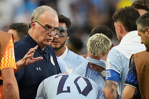 Uruguay head coach Marcelo Bielsa talks to his players during a hydration break in a World Cup Group H soccer match against Saudi Arabia in Miami Gardens, Fla., Monday, June 15, 2026.