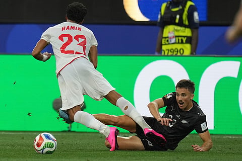 New Zealand's Ryan Thomas (23) battles for the ball with Iran's Ramin Rezaeian (23) during the World Cup Group G soccer match between Iran and New Zealand in Inglewood, Calif., near Los Angeles, Monday, June 15, 2026.