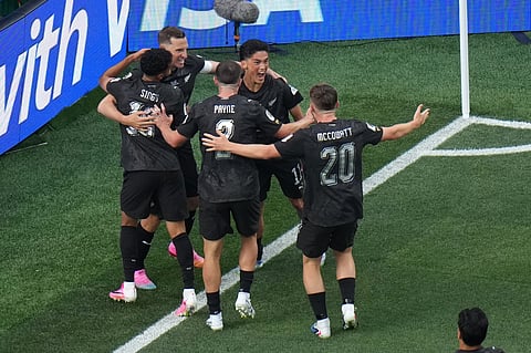 New Zealand's Elijah Just (11) celebrates with teammates after scoring their opening goal during the World Cup Group G soccer match between Iran and New Zealand in Inglewood, Calif., near Los Angeles, Monday, June 15, 2026.