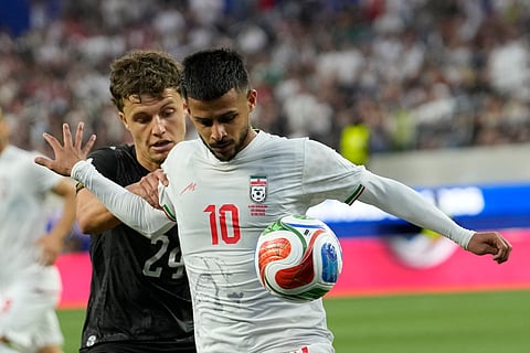 Iran's Mehdi Ghayedi (10) battles for the ball with New Zealand's Callan Elliot (24) during the World Cup Group G soccer match between Iran and New Zealand in Inglewood, Calif., near Los Angeles, Monday, June 15, 2026.