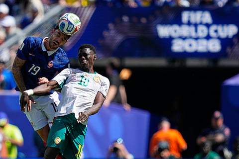 France's Theo Hernandez, left, jumps for the ball with Senegal's Ismaila Sarr during the World Cup Group I soccer match between France and Senegal in East Rutherford, N.J., near New York, Tuesday, June 16, 2026.