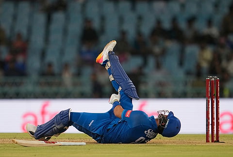 Afghanistan's Darwish Rasooli falls on ground after severe muscle pain while playing a shot during the second ODI cricket match between India and Afghanistan in Lucknow.