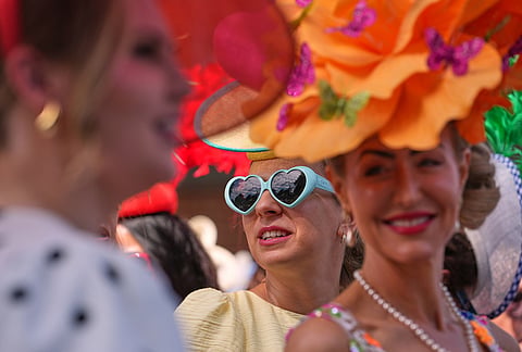 Racegoers queue at the entrance as they arrive on the first day of the Royal Ascot horse race meeting in Ascot, England.