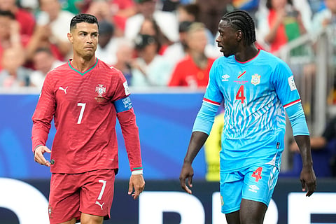 Portugal's Cristiano Ronaldo, left, and Congo's Axel Tuanzebe react during the World Cup Group K soccer match between Portugal and Congo in Houston