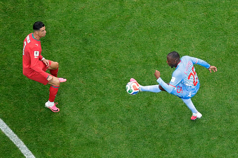 Congo's Edo Kayembe (25) tries to control the ball in front of Portugal's Cristiano Ronaldo (7) during the World Cup Group K match