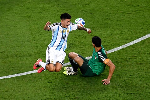 Argentina's Thiago Almada (16) challenges for the ball with Algeria's Aissa Mandi (2) during the World Cup Group J soccer match between Argentina and Algeria in Kansas City, Mo., Tuesday, June 16, 2026.