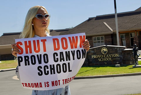 Paris Hilton protests outside the Provo Canyon School, where she says she suffered abuse as a teen, Monday, June 15, 2026, in Springville, Utah. 