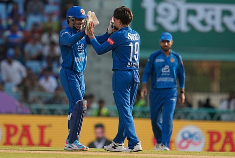 Afghanistan's Rashid Khan, center, celebrates the wicket of India's Washington Sundar during the second ODI cricket match between India and Afghanistan in Lucknow.