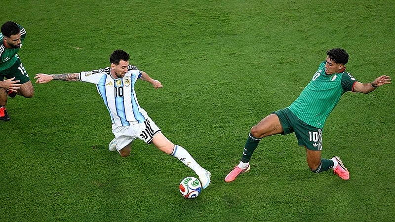 Argentina's Lionel Messi (10) battles for the ball with Algeria's Fares Chaibi (10) during the World Cup Group J soccer match between Argentina and Algeria in Kansas City, Mo., Tuesday, June 16, 2026.  - AP Photo/Reed Hoffmann