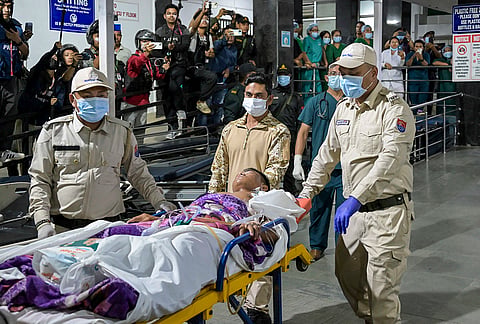 Security pesonnel wheel a patient on a stretcher during the transfer of three Kuki youths from the Regional Institute of Medical Sciences (RIMS), in Imphal, Manipur. The transfer was carried out under tight security following protests over their admission to the hospital. 