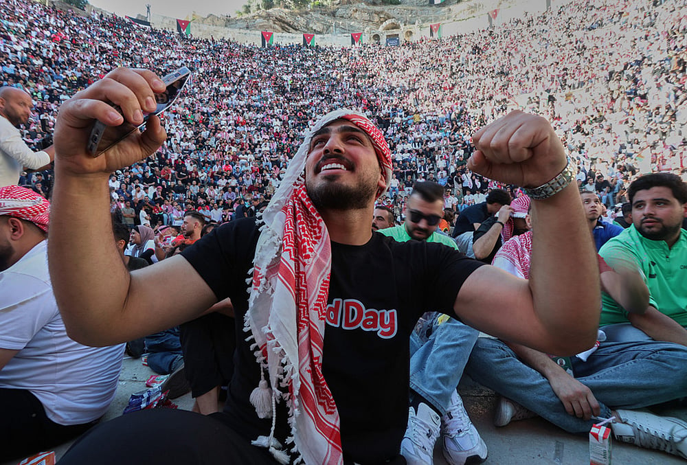 | Photo: AP/Raad Adayleh : A Jordanian soccer fan reacts while watching the World Cup match between Jordan and Austria on a large screen at the Roman Amphitheater in downtown Amman, Jordan.