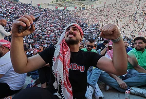 | Photo: AP/Raad Adayleh : A Jordanian soccer fan reacts while watching the World Cup match between Jordan and Austria on a large screen at the Roman Amphitheater in downtown Amman, Jordan.