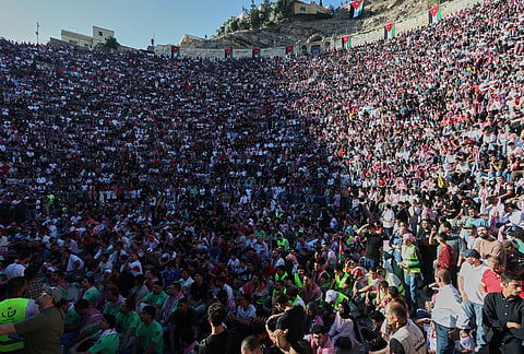 Jordanian soccer fans watch the World Cup match between Jordan and Austria on a large screen at the Roman Amphitheater in downtown Amman, Jordan.