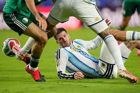 Argentina's Rodrigo de Paul falls as he chases the ball during the World Cup Group J soccer match between Argentina and Algeria in Kansas City, Mo., Tuesday, June 16, 2026.
