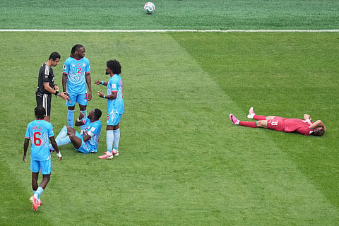 Congo players argue with a referee during the World Cup Group K soccer match between Portugal and Congo in Houston, Wednesday