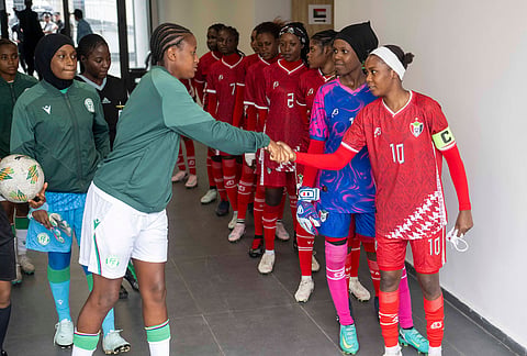 Sudan's U-17 women's national team, left, shakes hand with Comorros women's national team, ahead of their soccer match during qualifiers for the 2028 Los Angeles Summer Olympics, in Casablanca, Morocco.
