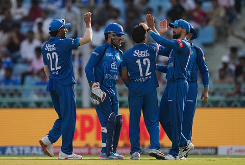 Afghanistan's players celebrate the wicket of India's Shreyas Iyer during the second ODI cricket match between India and Afghanistan in Lucknow.